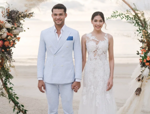 Malek is wearing a baby blue striped seersucker cotton suit for a Wedding Notebook shoot